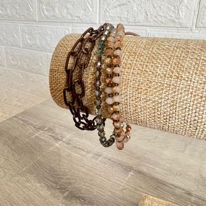 Multi textured bracelet with beads and chains.